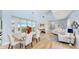 Elegant dining room with light wood floors and access to balcony at 10101 Eagle Preserve Dr, Englewood, FL 34224