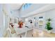 Bright dining room with large table, hardwood floors, and access to kitchen at 10101 Eagle Preserve Dr, Englewood, FL 34224