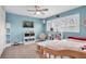 Light blue bedroom with a daybed, built-in shelving, and window shutters at 901 31St Ne Ter, St Petersburg, FL 33704