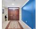 Grand entryway with rich hardwood floors and blue accent wall at 901 31St Ne Ter, St Petersburg, FL 33704