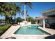 Relaxing kidney-shaped pool with patio furniture and fire pit at 901 31St Ne Ter, St Petersburg, FL 33704