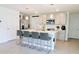 Modern kitchen with island, stainless steel appliances, and grey cabinets at 12113 Water Ash Pl, Riverview, FL 33569