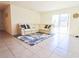 Spacious living room with sectional sofa and large rug at 12113 Water Ash Pl, Riverview, FL 33569