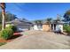 Front view of the house with a gray garage door at 4147 Marine Pkwy, New Port Richey, FL 34652