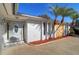 House exterior with gray door and palm trees at 4147 Marine Pkwy, New Port Richey, FL 34652