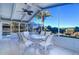 Bright sunroom with table and chairs, offering water views at 4147 Marine Pkwy, New Port Richey, FL 34652