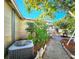 Exterior side yard featuring mature landscaping, partial fence, and access to backyard at 7521 Coventry Dr, Port Richey, FL 34668