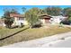 Charming single-story home featuring a front yard with mature landscaping and a covered entrance at 7521 Coventry Dr, Port Richey, FL 34668