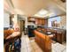Kitchen features wood cabinets, island, and tin backsplash at 7521 Coventry Dr, Port Richey, FL 34668