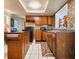 Kitchen with wood cabinets, island, and tin backsplash at 7521 Coventry Dr, Port Richey, FL 34668