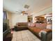 Living room with sectional sofa and ceiling fan at 7521 Coventry Dr, Port Richey, FL 34668