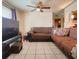 Living room with sectional sofa and ceiling fan at 7521 Coventry Dr, Port Richey, FL 34668