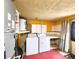 An interior utility room featuring washer, dryer, water heater, and storage at 7521 Coventry Dr, Port Richey, FL 34668