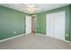 Bedroom with ceiling fan, neutral walls, and double door closet at 5627 War Admiral Dr, Wesley Chapel, FL 33544