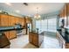 Modern kitchen featuring wood cabinets, granite counters and island at 5627 War Admiral Dr, Wesley Chapel, FL 33544