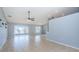 Open living area with tile floors and a ceiling fan at 5627 War Admiral Dr, Wesley Chapel, FL 33544