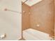 Clean bathroom with light brown tiled walls and a bathtub at 708 Fern Leaf Dr, Ruskin, FL 33570