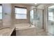 Spa-like bathroom with soaking tub, shower, and granite vanity at 708 Fern Leaf Dr, Ruskin, FL 33570