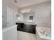 Double vanity bathroom with granite countertop and large mirror at 708 Fern Leaf Dr, Ruskin, FL 33570