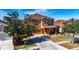 Two-story house with a brown exterior, driveway, and landscaping at 708 Fern Leaf Dr, Ruskin, FL 33570