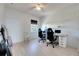 Bright home office features wood flooring, window, and built-in shelving at 708 Fern Leaf Dr, Ruskin, FL 33570