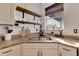 Kitchen features a corner sink, granite counters, and open shelving at 708 Fern Leaf Dr, Ruskin, FL 33570