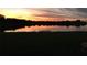 Stunning lake view at sunset, reflecting homes at 708 Fern Leaf Dr, Ruskin, FL 33570