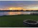 Stunning sunset over the lake, backyard with fire pit at 708 Fern Leaf Dr, Ruskin, FL 33570
