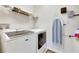 Bright laundry room with washer, dryer, and shelving at 708 Fern Leaf Dr, Ruskin, FL 33570