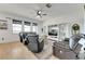 Living room with large windows, hardwood floors, and comfortable seating at 708 Fern Leaf Dr, Ruskin, FL 33570