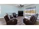 Relaxing living room with sliding doors to a view at 12726 Mountain Springs Pl, New Port Richey, FL 34655