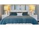 Primary bed with glamorous headboard and bedding at 175 2Nd S St # P-08, St Petersburg, FL 33701