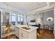 Bright kitchen boasts white cabinetry, marble countertops, and two sinks at 175 2Nd S St # P-08, St Petersburg, FL 33701
