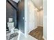 Small powder room with dark wallpaper and updated toilet at 5935 Maidenstone Way, Palmetto, FL 34221