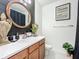 Elegant bathroom with a modern vanity and dark wood accents at 5935 Maidenstone Way, Palmetto, FL 34221
