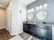 Double vanity bathroom with granite countertop and stylish mirrors at 5935 Maidenstone Way, Palmetto, FL 34221