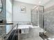 Elegant bathroom with soaking tub, walk-in shower, and granite vanity at 5935 Maidenstone Way, Palmetto, FL 34221