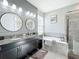 Elegant bathroom with double vanity, soaking tub, and walk-in shower at 5935 Maidenstone Way, Palmetto, FL 34221