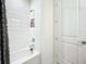 Clean bathroom with a shower/tub combo and white tile at 5935 Maidenstone Way, Palmetto, FL 34221