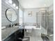 Spa-like bathroom with double vanity, soaking tub, and walk-in shower at 5935 Maidenstone Way, Palmetto, FL 34221
