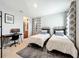 Bright bedroom with twin beds, a workspace, and stylish decor at 5935 Maidenstone Way, Palmetto, FL 34221