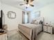Serene bedroom with a queen bed and ceiling fan at 5935 Maidenstone Way, Palmetto, FL 34221