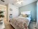 Well-lit bedroom with a queen bed and light green wall at 5935 Maidenstone Way, Palmetto, FL 34221