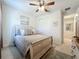 Cozy bedroom with a queen bed, ceiling fan, and built-in closet at 5935 Maidenstone Way, Palmetto, FL 34221