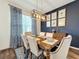 Elegant dining room with dark wood table and blue patterned curtains at 5935 Maidenstone Way, Palmetto, FL 34221