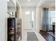 Front entry featuring a tiled floor, decorative cabinet, and natural light at 5935 Maidenstone Way, Palmetto, FL 34221