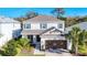 Two-story home with a brown garage door and landscaped front yard at 5935 Maidenstone Way, Palmetto, FL 34221