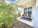 Cozy front porch with two wicker chairs and a welcome mat at 5935 Maidenstone Way, Palmetto, FL 34221