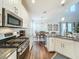Modern kitchen with granite countertops, stainless steel appliances, and white cabinets at 5935 Maidenstone Way, Palmetto, FL 34221