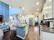 Open concept kitchen with island, stainless steel appliances, and hardwood floors at 5935 Maidenstone Way, Palmetto, FL 34221